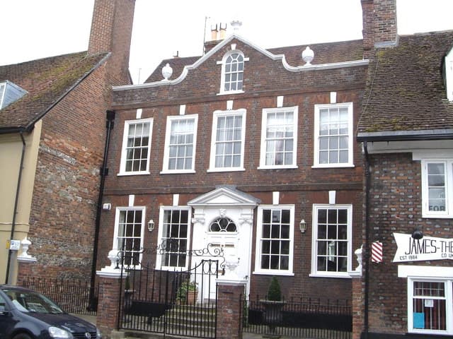 Eastway House, Blandford Forum — decorative Georgian facade with curvy parapet, urns and balls