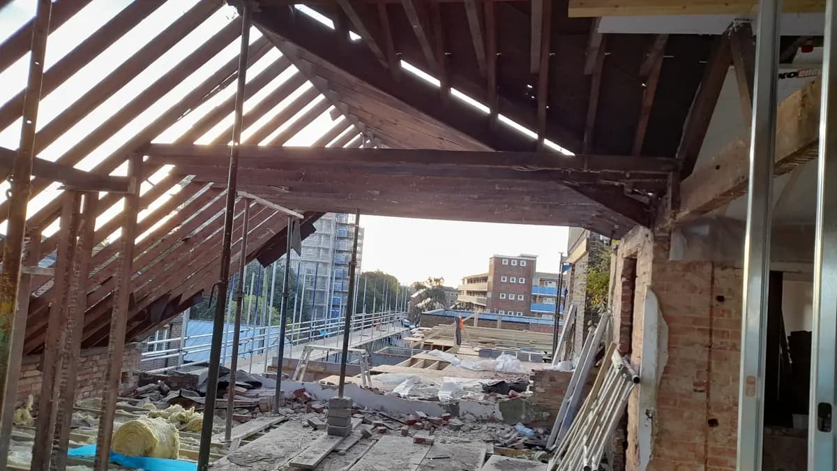 Open attic renovation with exposed rafters, brickwork and insulation