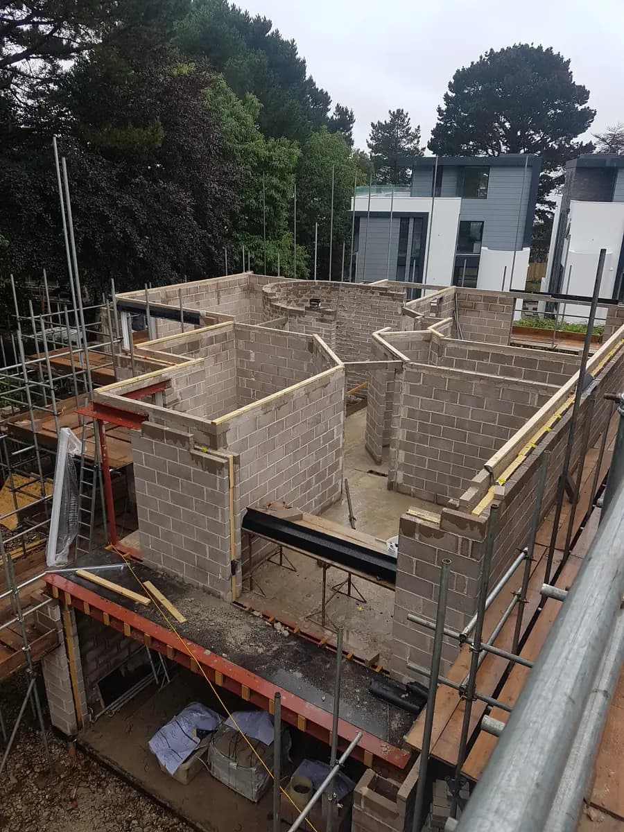 Concrete block walls, steel beams, timber formwork and scaffolding