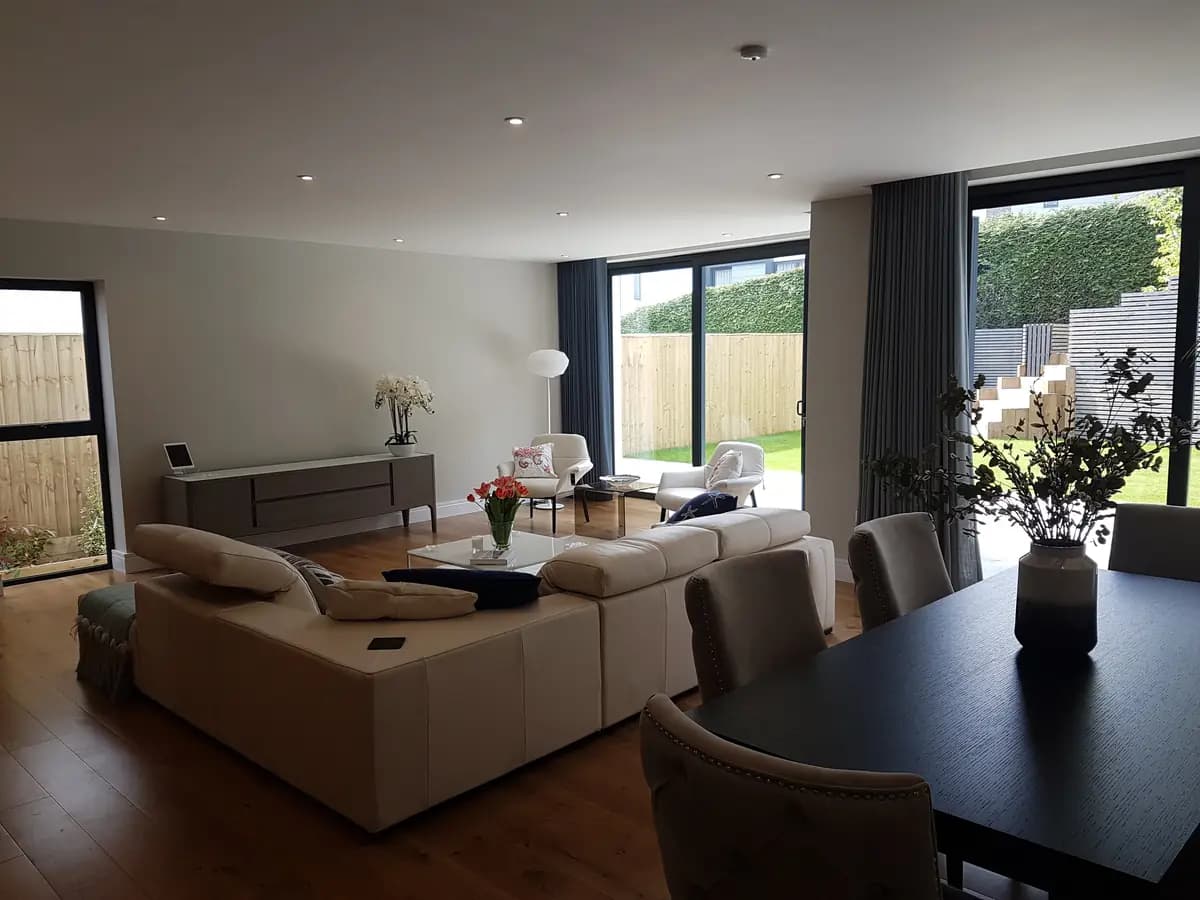 Finished open-plan living space with large garden-facing glazing
