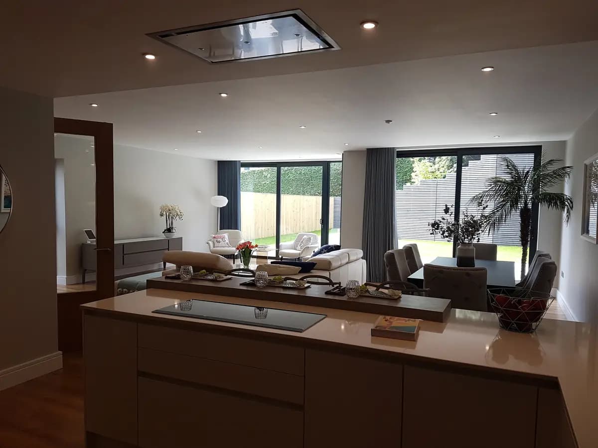 Modern open-plan interior with kitchen island, skylight and living area
