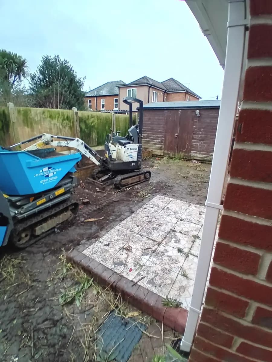 Bobcat mini excavator and tracked dumper in a residential garden excavation