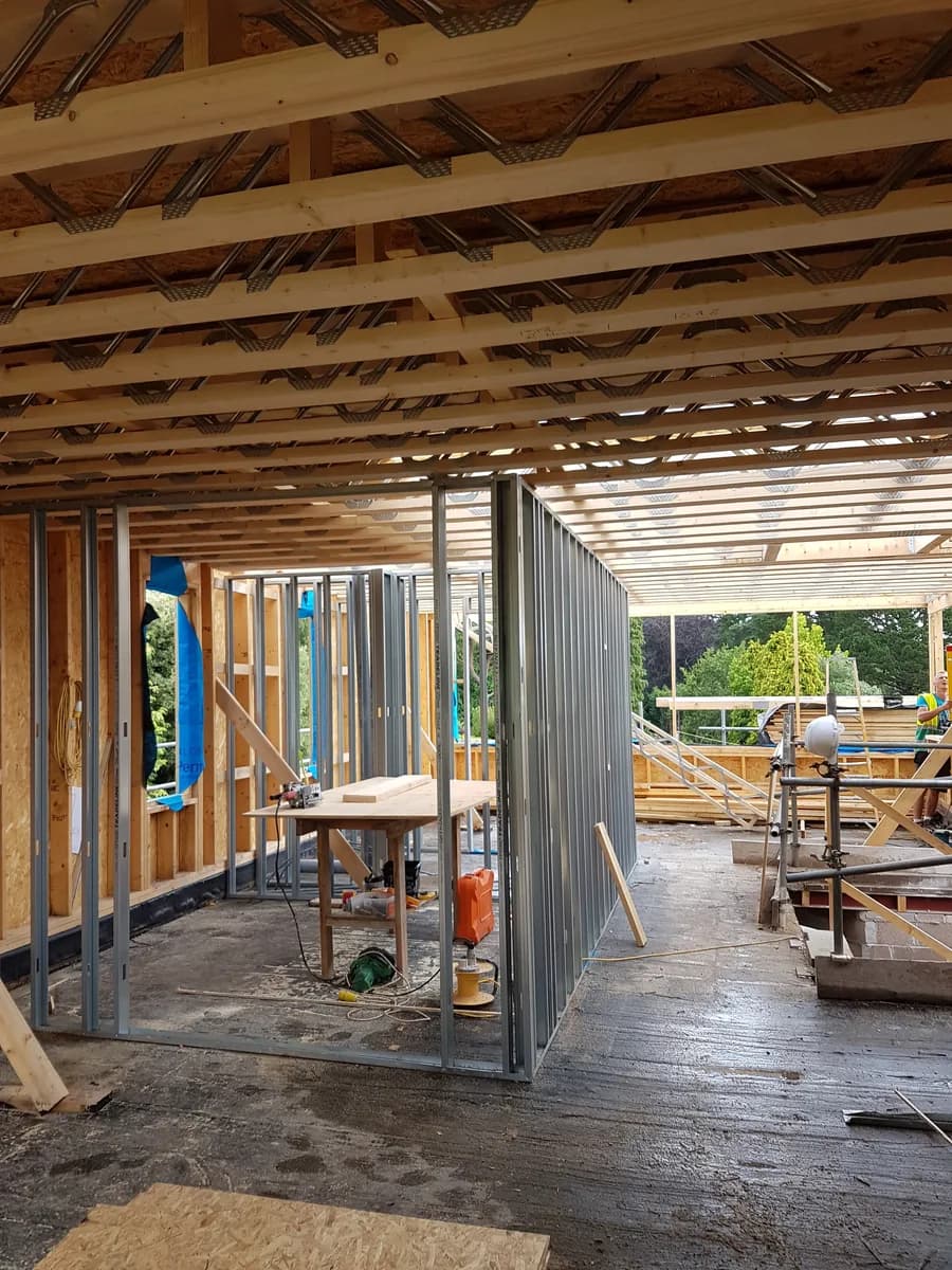 Interior construction with exposed metal web joists, metal studs and tools