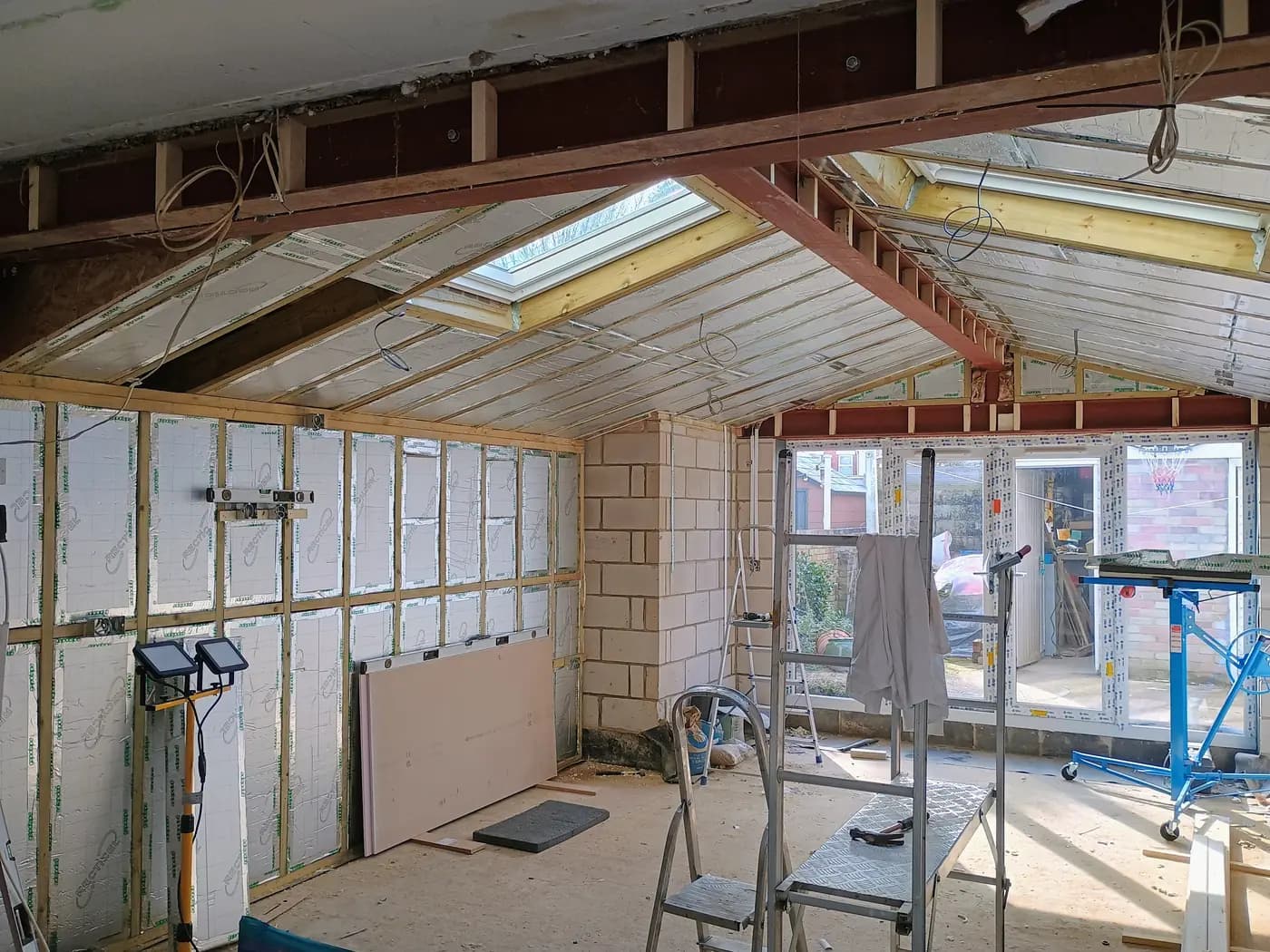 Loft renovation with foil insulation, skylights, timber framing and tools