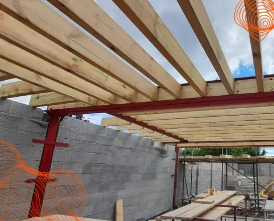 Timber roof framing installed on a red steel structure and blockwork
